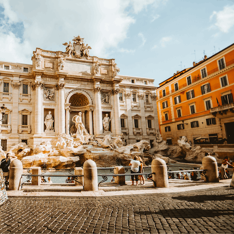 Walk up to the beautiful Trevi Fountain, known for its intricacy and history