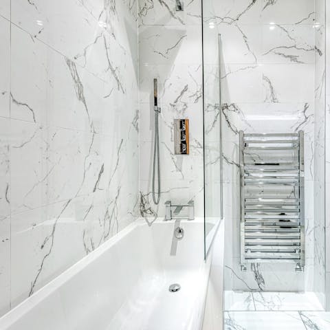 Sink into steamy waters in the pristine marble bathroom