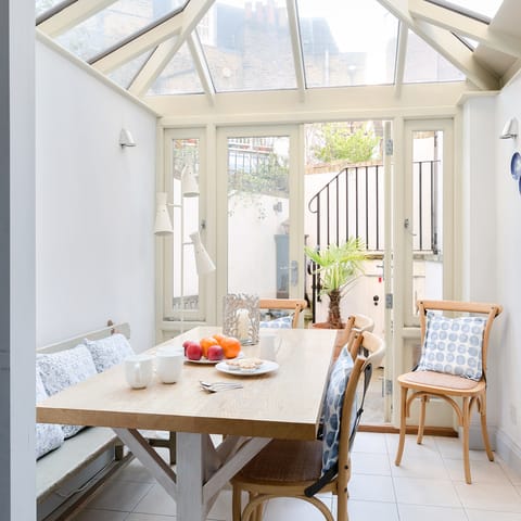 Gather for a family meal in the sun-filled conservatory 