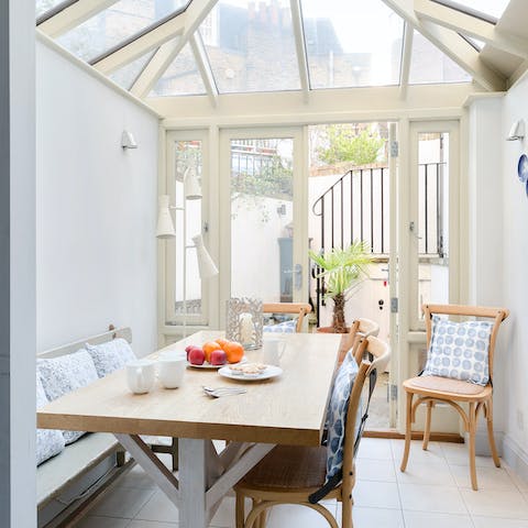 Gather for a family meal in the sun-filled conservatory 