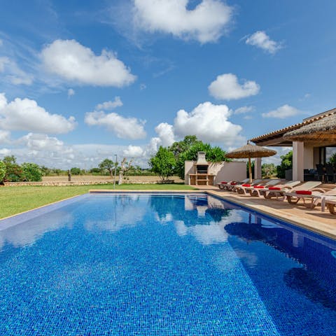Spend a lazy afternoon at home, flitting between the loungers and the pool