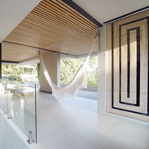 Enjoy idyllic jungle views while swaying in the hammock