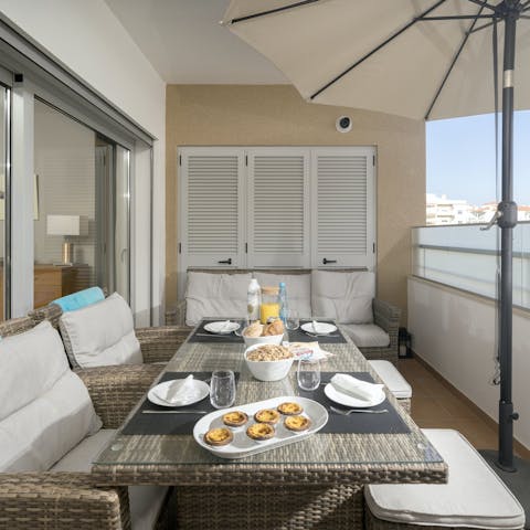 Dig into alfresco bacalhau à brás on one of the private balconies