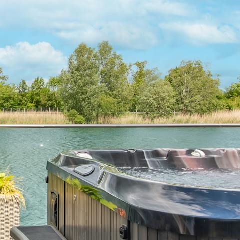 Immerse yourself in the warmth of the hot tub and enjoy the magic of this lakeside setting