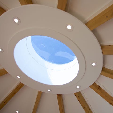 Wake to the sun and bid goodnight to the glistening stars courtesy of the central skylight
