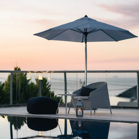 Watch the sunset over the sparkling seascape from the terrace