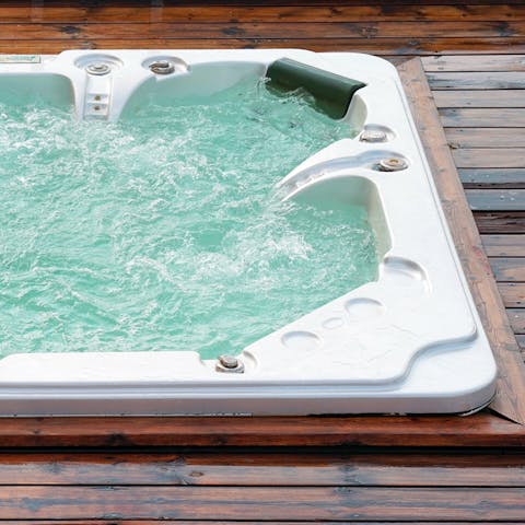 Enjoy a long soak in the garden Jacuzzi after a day on the beach