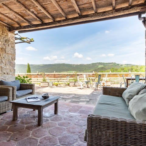 Take your evening tipple on the lounge patio with a view of the Tuscan hills