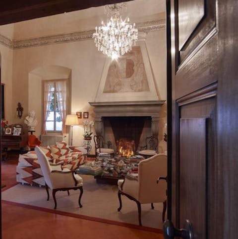 Cosy up by the statement fireplace in this grand sitting room