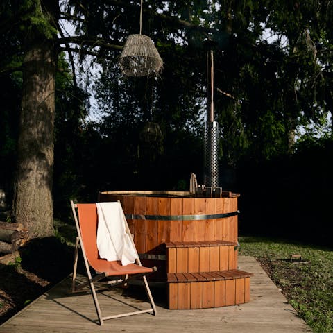 Relax in the wood-fired Nordic bath set under towering pine trees