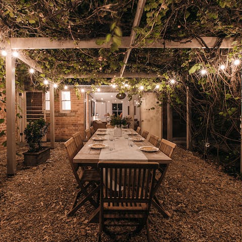 Stay out long after dinner enjoying drinks under the fairy-lit pergola