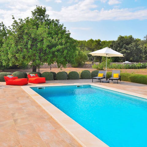 Luxuriate in your private, outdoor pool surrounded by greenery