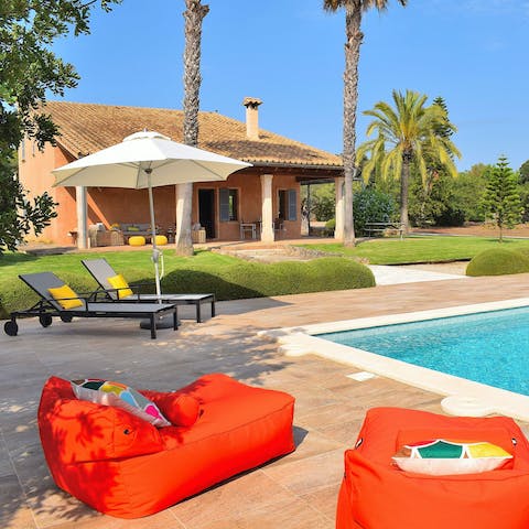 Lounge or laze in the sun by the pool