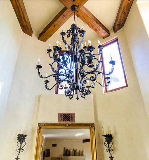 The wrought-iron chandelier