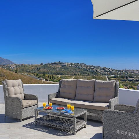 Spend late afternoons sipping on cocktails, catching up, and taking in the view on the outdoor sofa