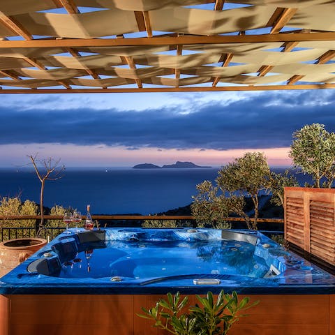 Watch the sunset from the bubbles of the hot tub with a glass of fizz in hand