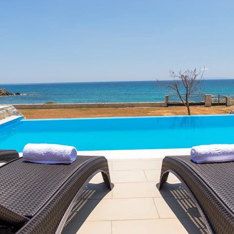 Admire the views over the infinity pool to the Libyan Sea