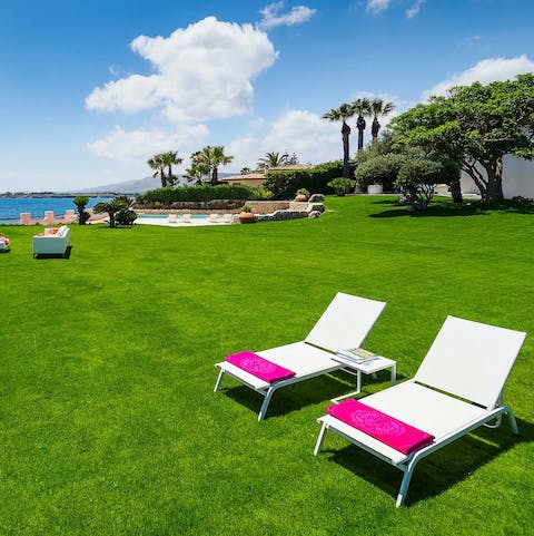 Relax with a book on the expansive manicured lawns