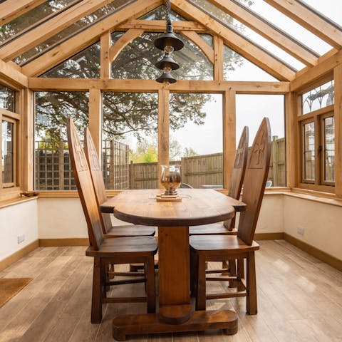 Enjoy breakfast on the conservatory table, lit by the morning sun