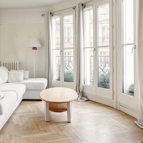 Admire the architecture and boulevard vistas through the French doors