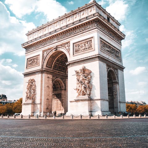 Visit the Arc de Triomphe, under half an hour walk or a ten-minute ride away