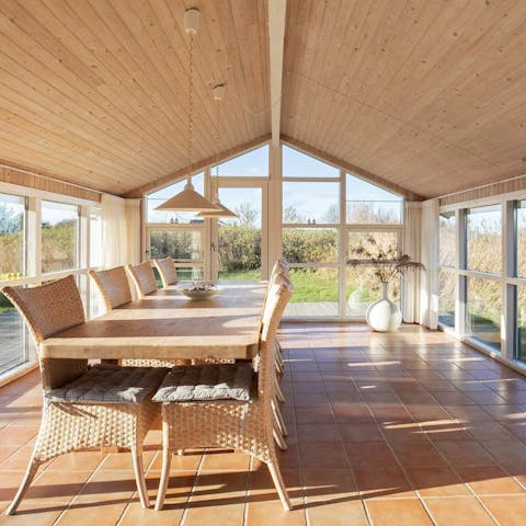 Dine in style beneath the wooden ceiling of this conservatory-like space