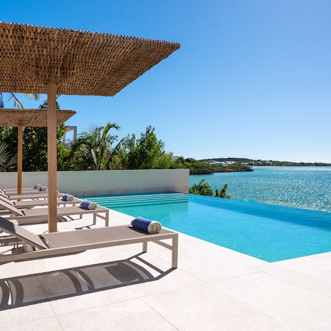 Jump into the villa's infinity pool and retire to a shaded lounger after a dip