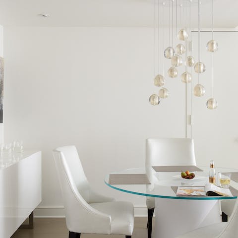 Dine underneath the hanging orb light in the living area