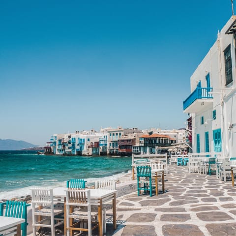 Head to the waterfront cafés of Mykonos Town, a ten-minute drive away