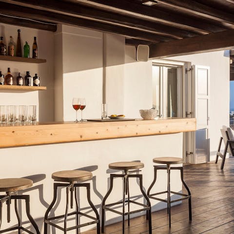 Take your sundowner at the fully-stocked bar outside