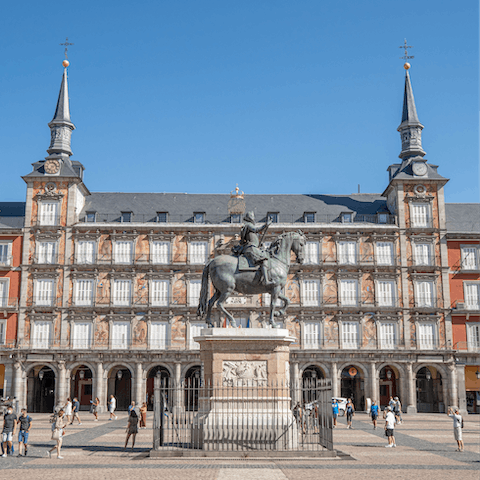 Explore bustling Plaza Mayor, a ten-minute walk away