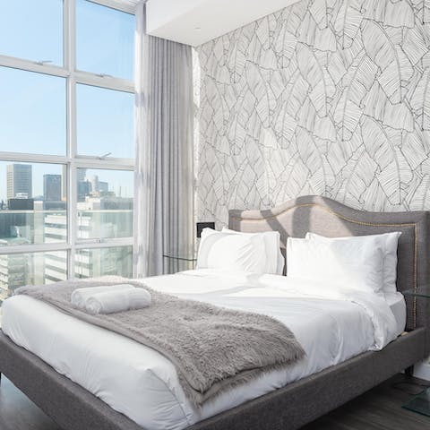 Wake up to city views in your comfortable hotel-quality bed