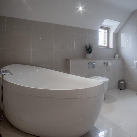 Treat yourself to a long soak in the elegant freestanding bathtub