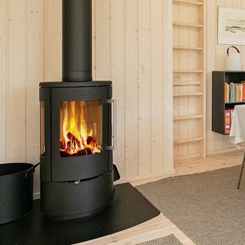 Spend cosy evenings curled up beside the warm glow of the wood-burning stove