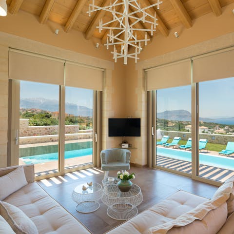 Chill out in the poolside living room with gorgeous mountainous landscapes in the background  