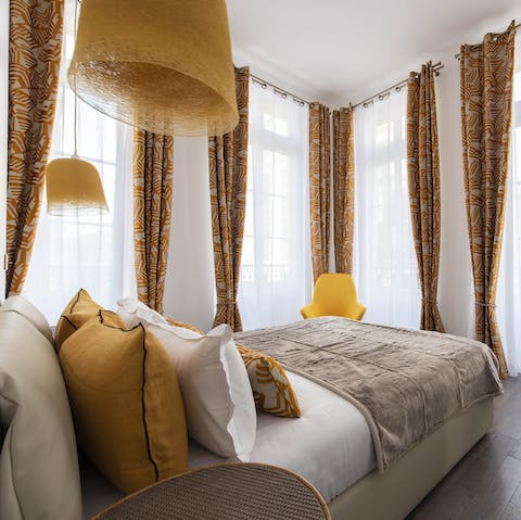 Wake up to beautiful floor-to-ceiling views of the Marais in the stylish bedroom 