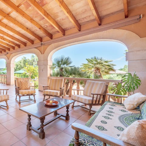Share a bottle of your favourite tipple on the covered terrace at sundown
