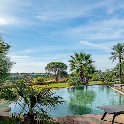 Take a siesta in the poolside hammock, with views over the Sicilian countryside