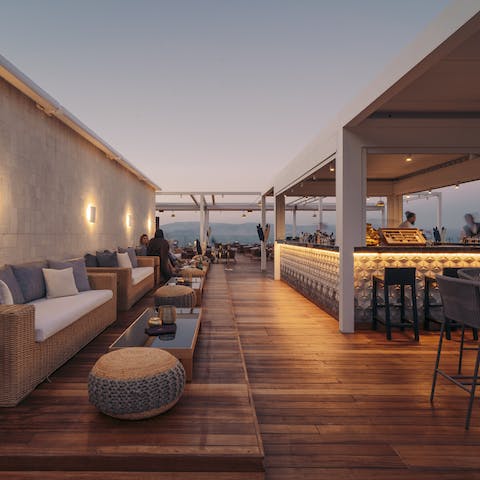 Sip on a glass of Greek wine in the trendy bar on the shared rooftop terrace
