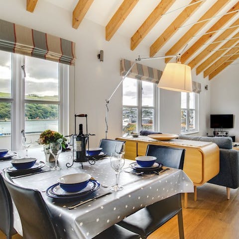 Gather together around the dining room table while enjoying captivating Cornish views