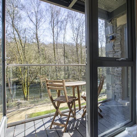 Enjoy a quiet moment alone on your private balcony, looking out over the trees