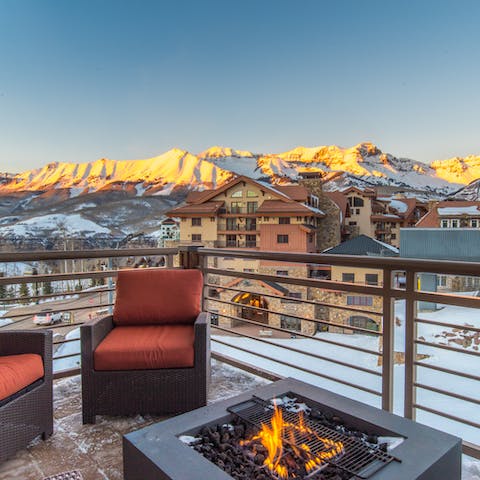 Watch the sunset over the mountain around the firepit