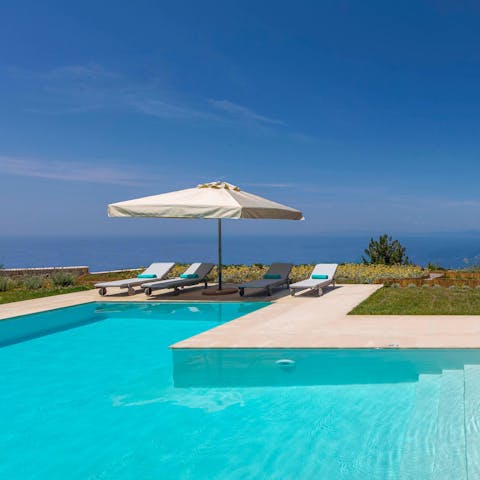 Glide gracefully through the swimming pool and admire the Aegean backdrop