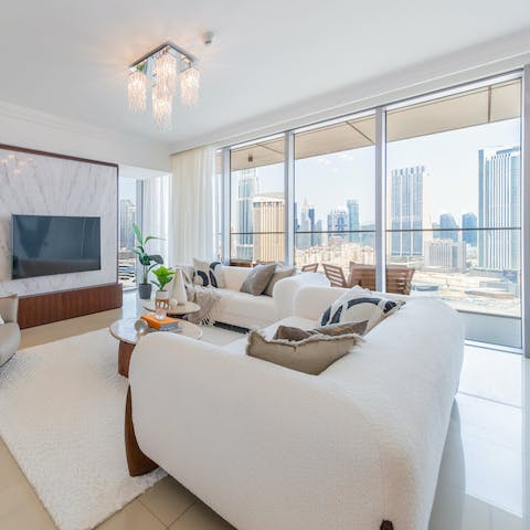 Relax in the lavish living room with its city skyline view