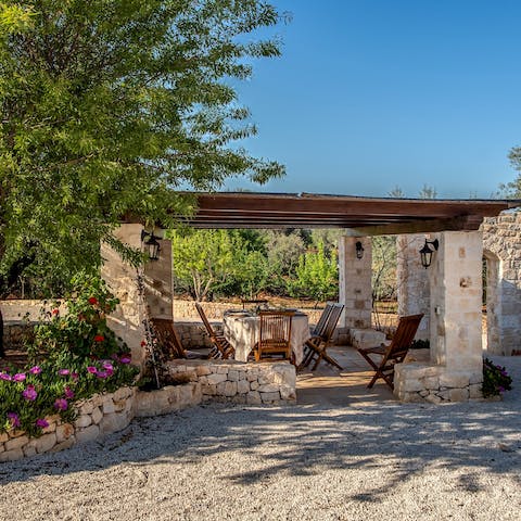 Tuck into sumptuous plates beneath the pergola