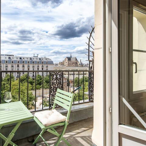 Drink wine on the private balcony as Paris buzzes with life below