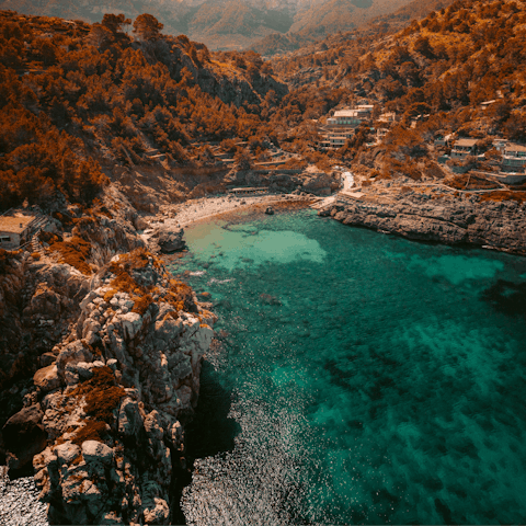 Lounge on the rocky shores of Cala Deia and swim in its crystal-clear waters