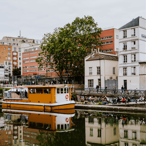 Watch boats pootle along the Saint Martin canal from a waterside bar, just a three-minute walk away