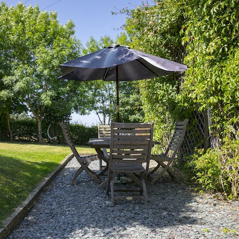 Gather around the garden table for summer evenings of salads, cheese boards, and jugs of Pimms