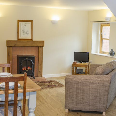 Spend cosy evenings sinking into the sofa, watching a comforting film while the fireplace warms you up